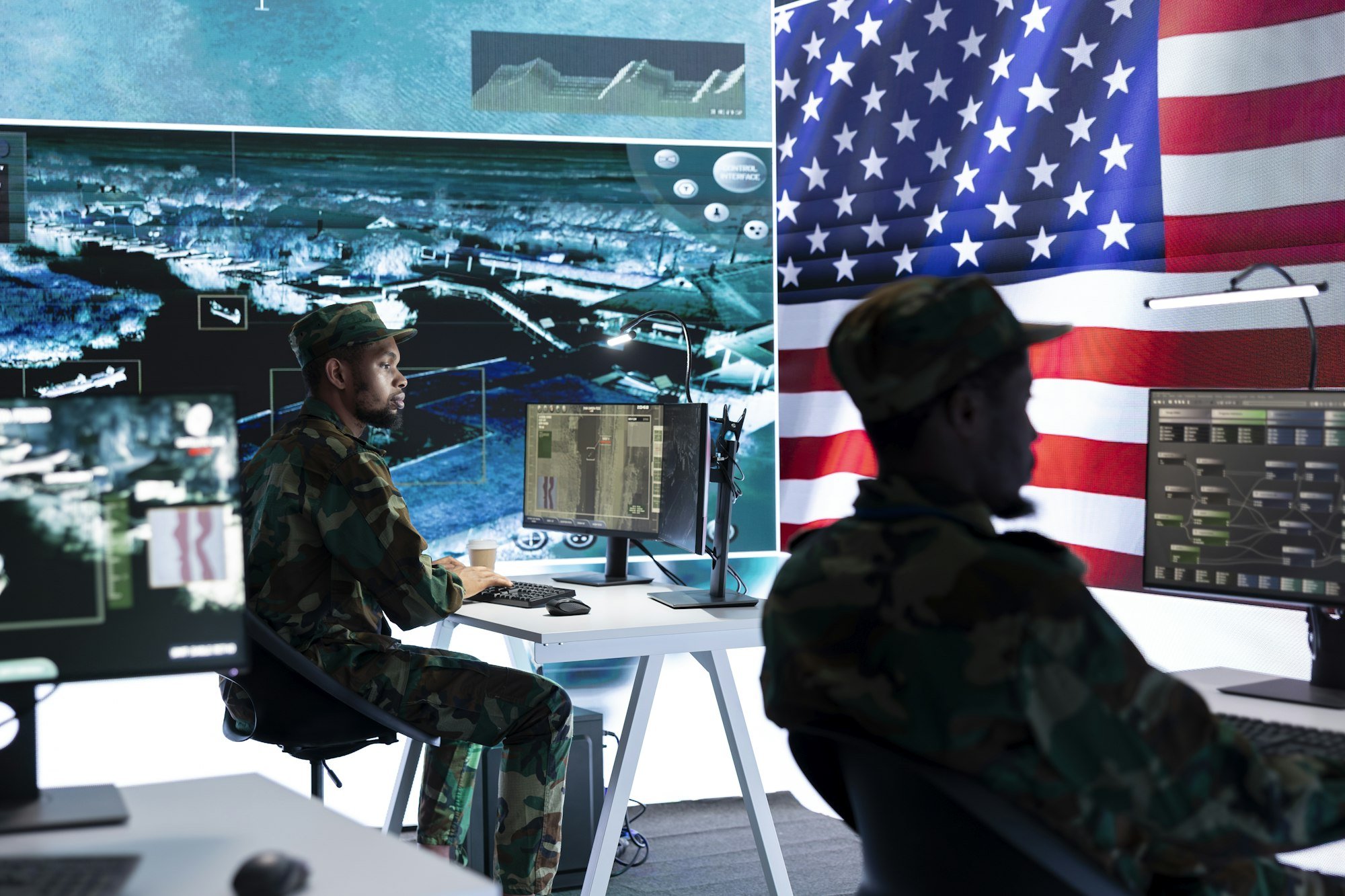 US military officer supervising threat detection activity in high tech office US military officer supervising threat detection activity in high tech office